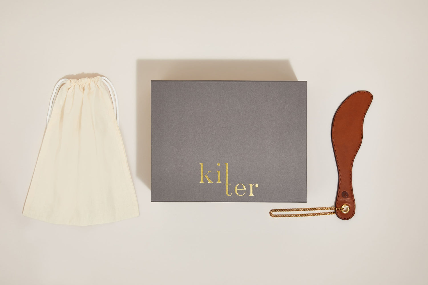 The Kilter Classic Paddle beside the branded presentation box and dust bag.