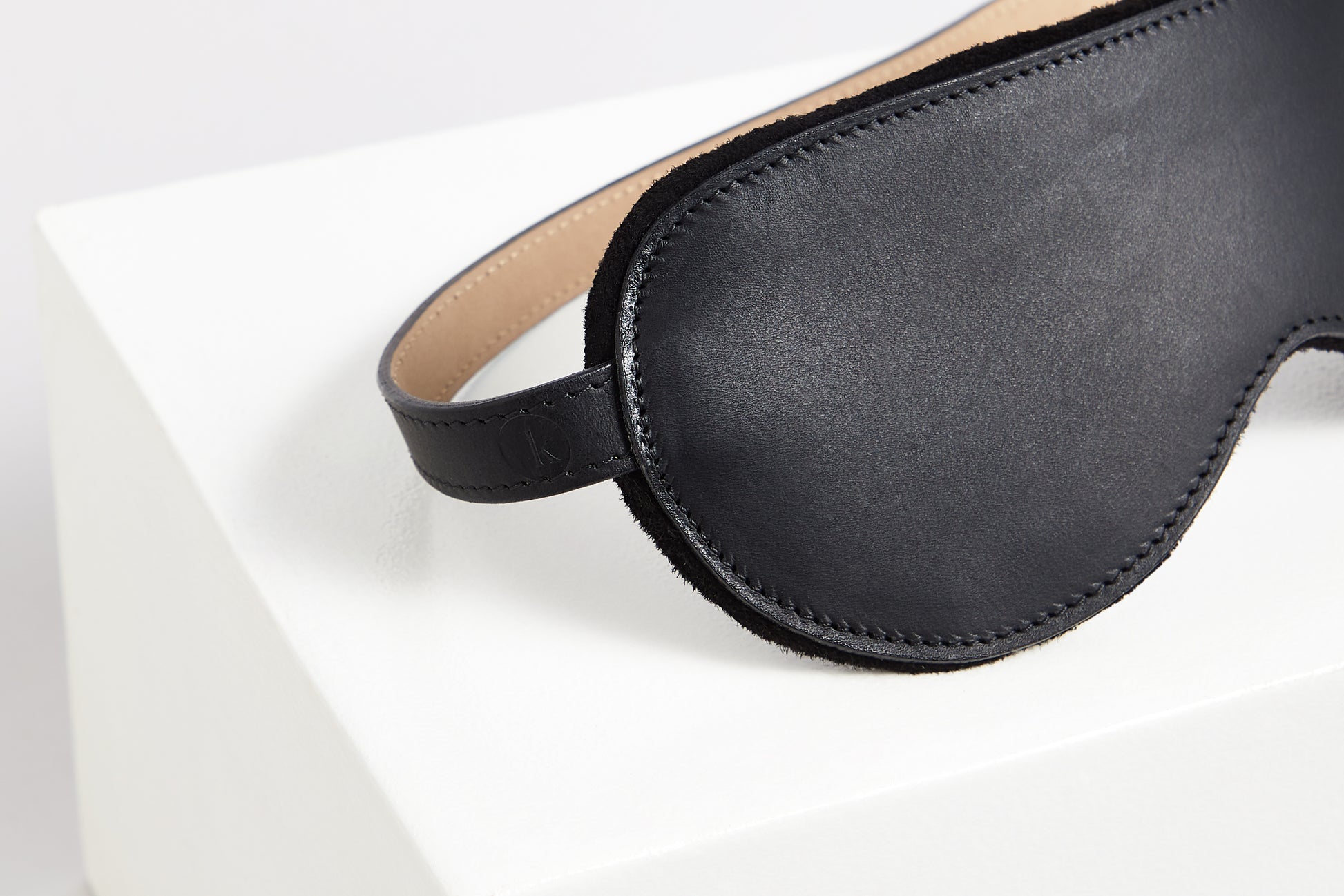 Detail of leather blindfold with Kilter logo embossed on the strap