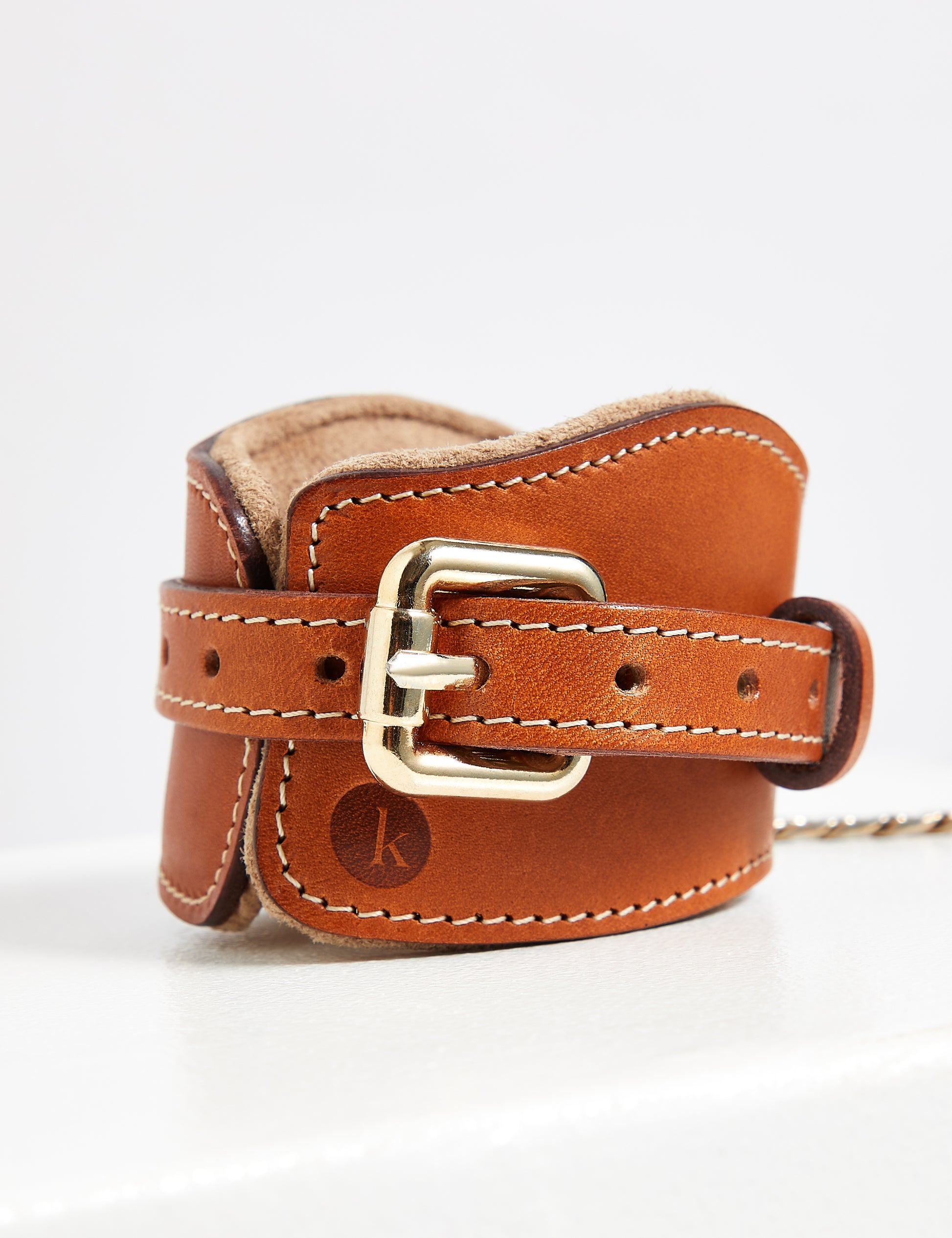 Luxury leather wrist restraints for BDSM in tan with gold hardware